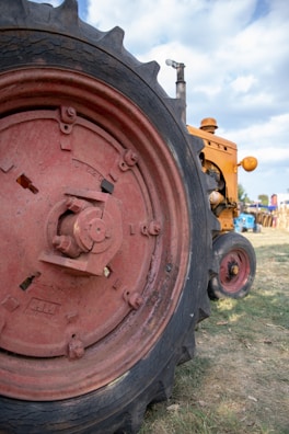 Close-up of a tractor tire filled with liquid ballast on a sunny farm field.