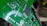 A close-up view of a green printed circuit board with various electronic components, including a black integrated circuit chip in the center. The circuit board has multiple silver solder points and white printed labels such as 'Driver'.