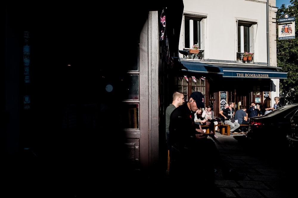 people beside building during day