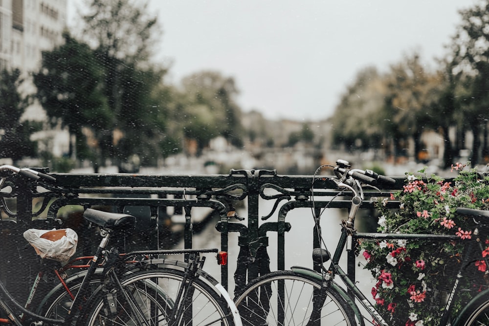 two bikes leaning on railing