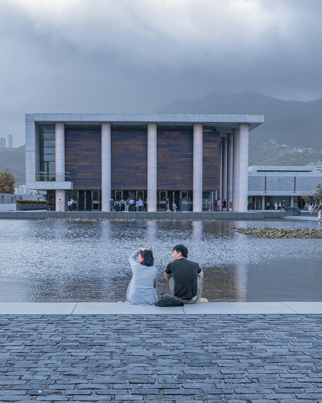 man and woman sitting outdoors