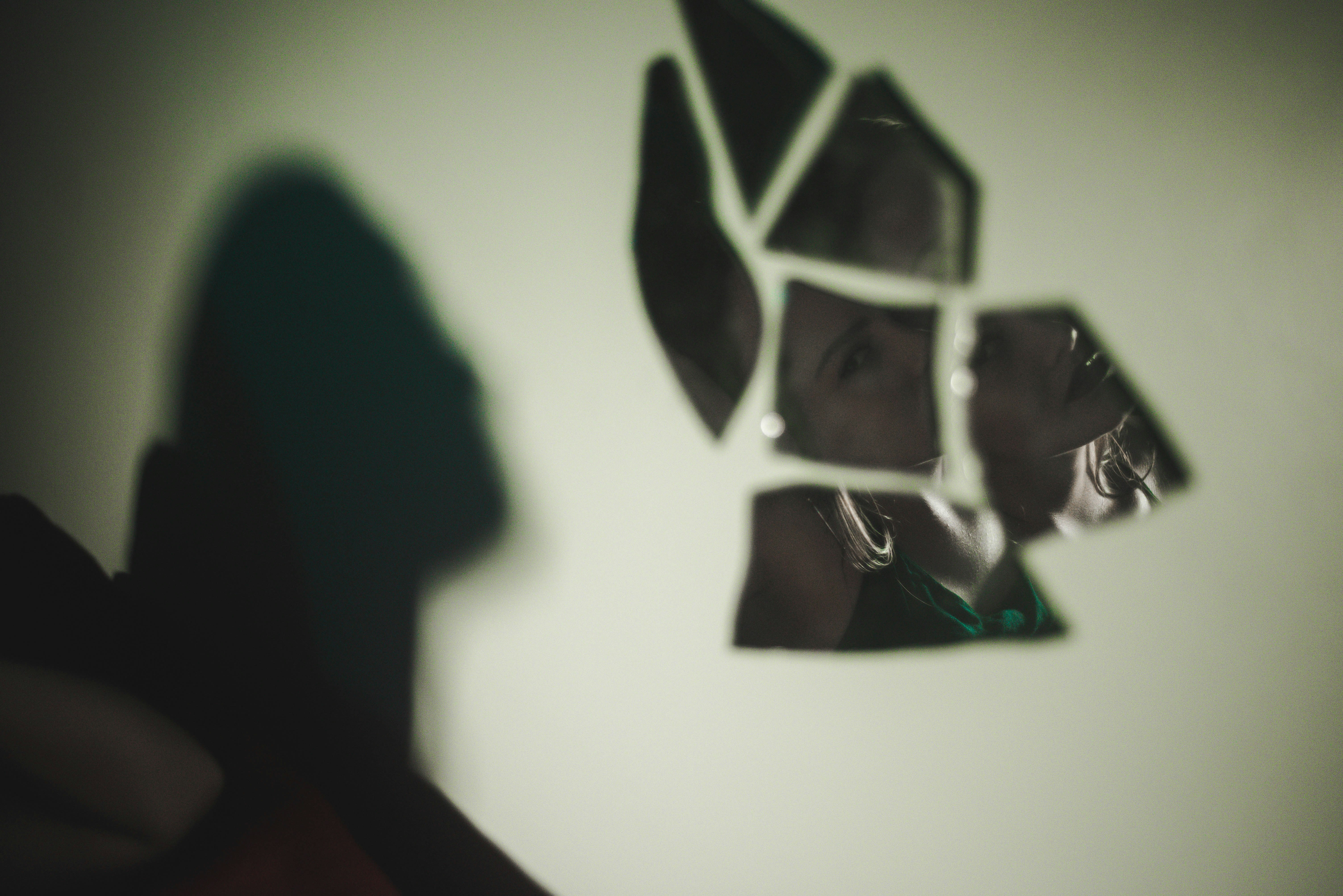 broken glass mirror with woman's reflection