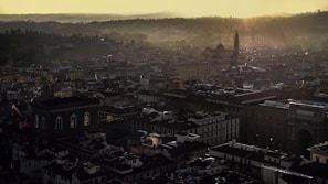 A sprawling ancient city with towering spires and bustling markets under a twilight sky.