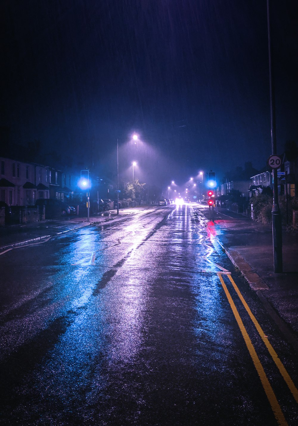 a wet street at night with street lights