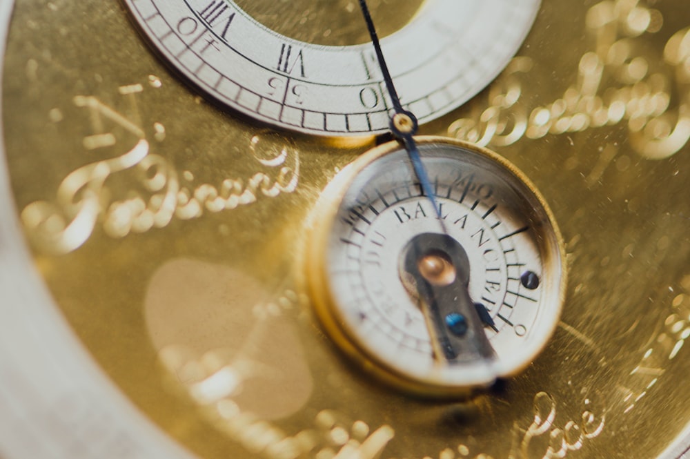 round brass-colored clock