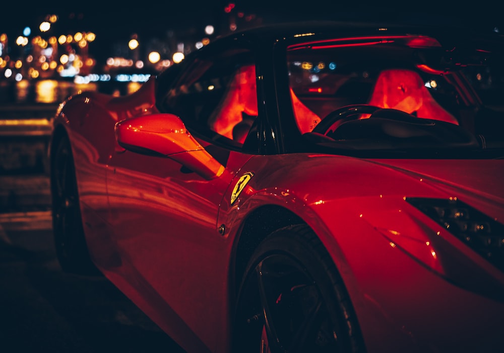 red Ferrari sports car during nighttime