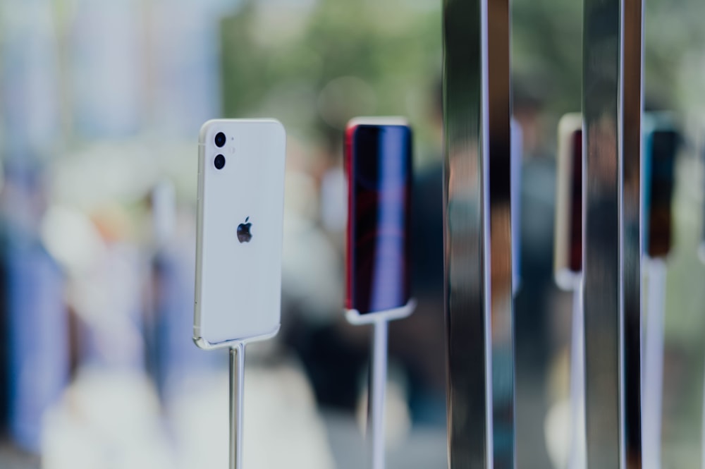 silver iPhone 11 displaying near glass shelf