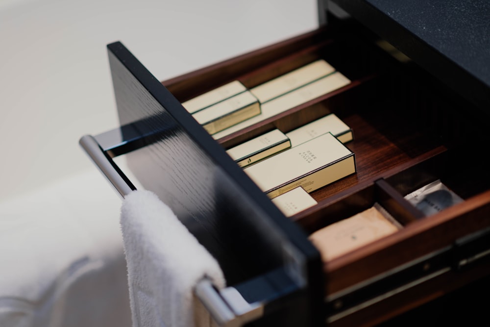 boxes inside black wooden drawer