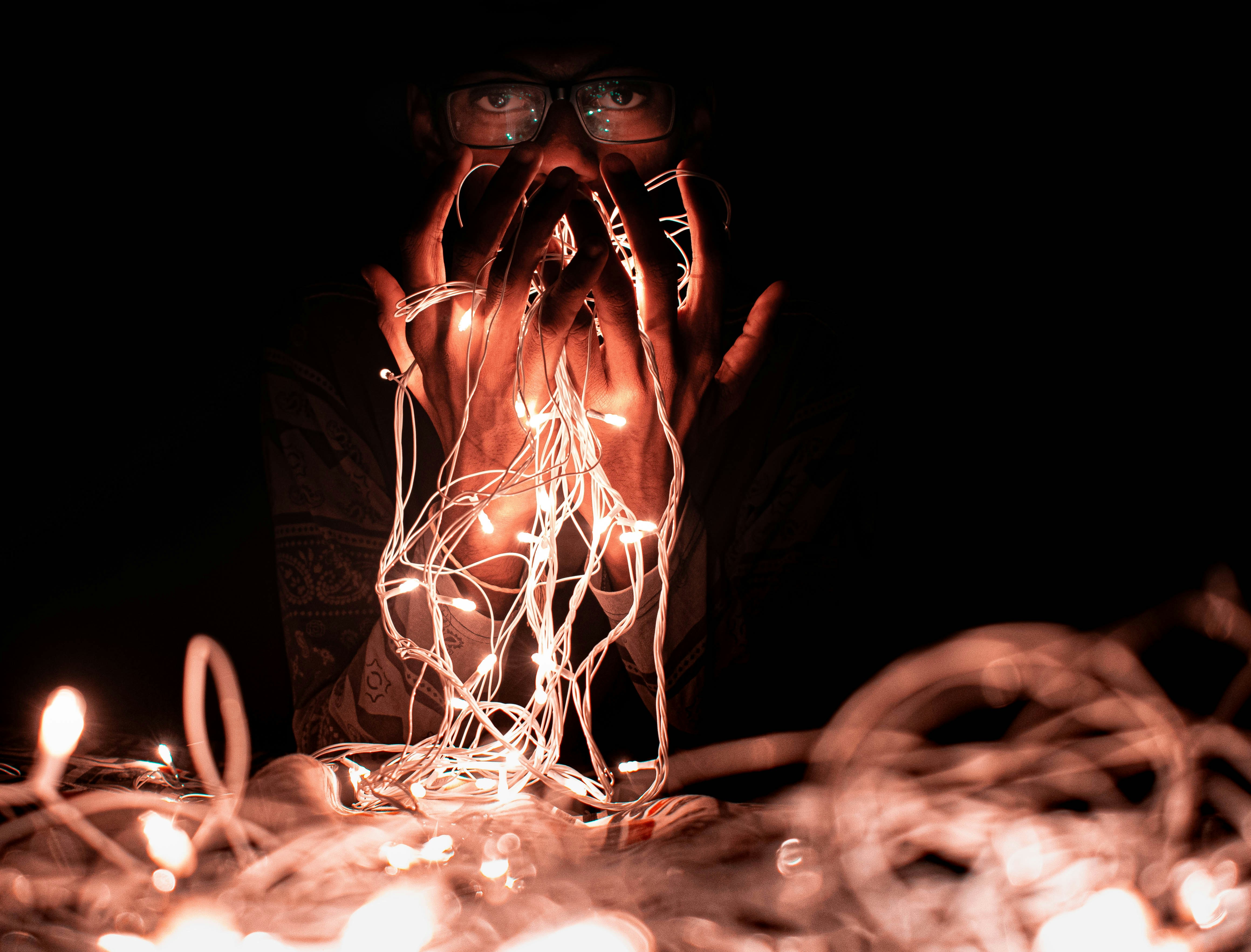 person holding string lights