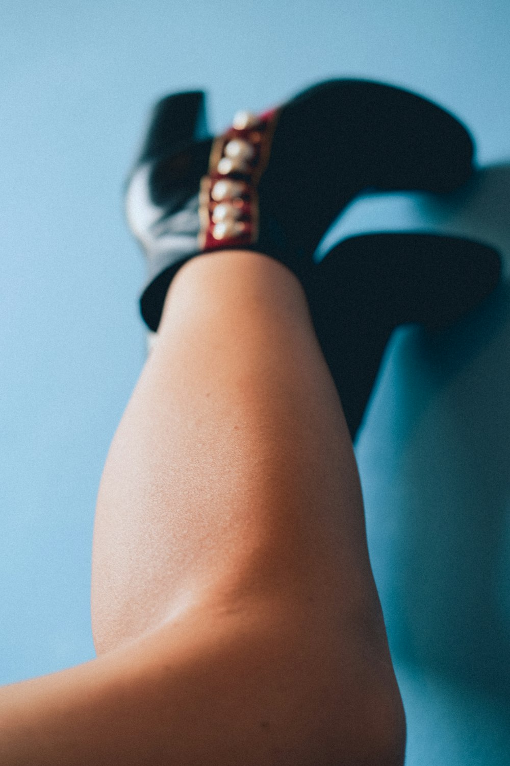 a close up of a person's legs wearing high heels