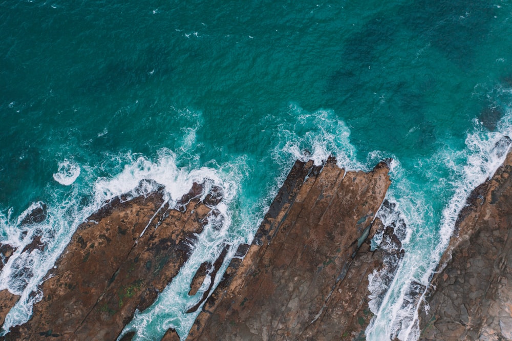 aerial photography of cliff near body of water during daytime