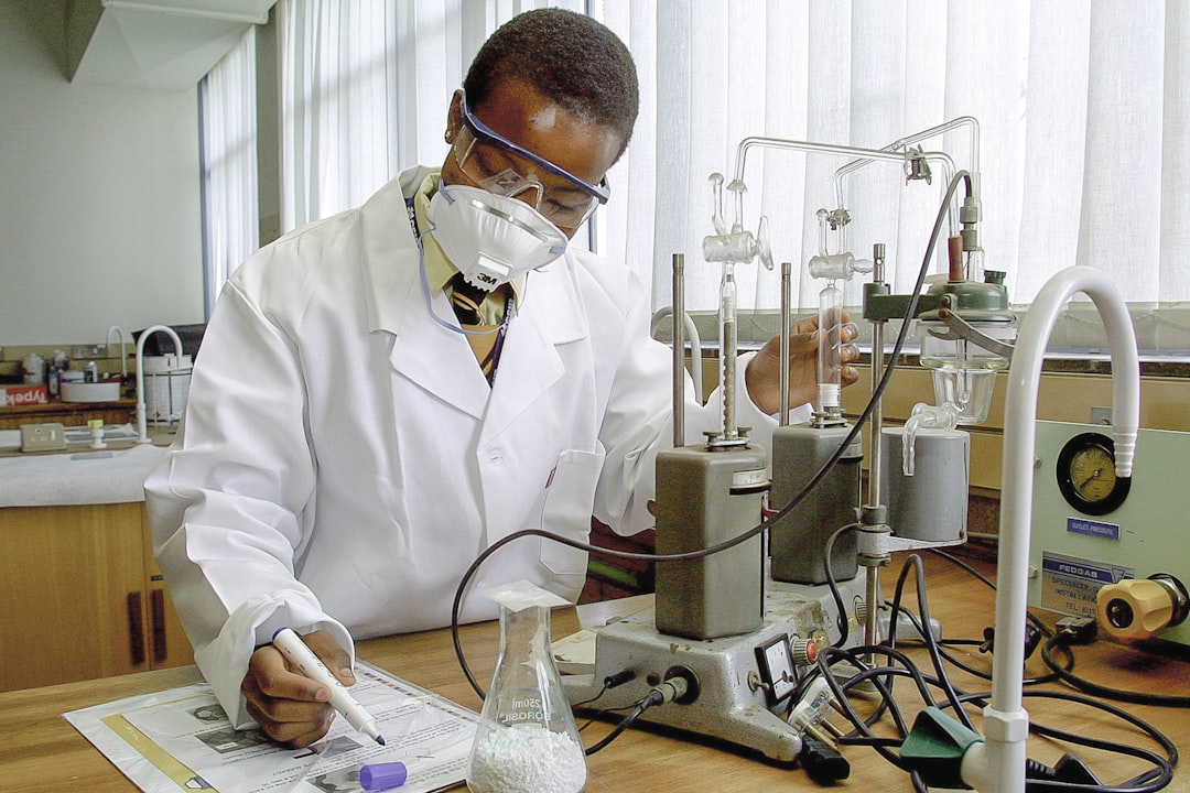 A student writes in a lab with equipment set up