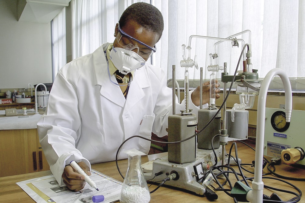 man inside laboratory experiments and write down the details