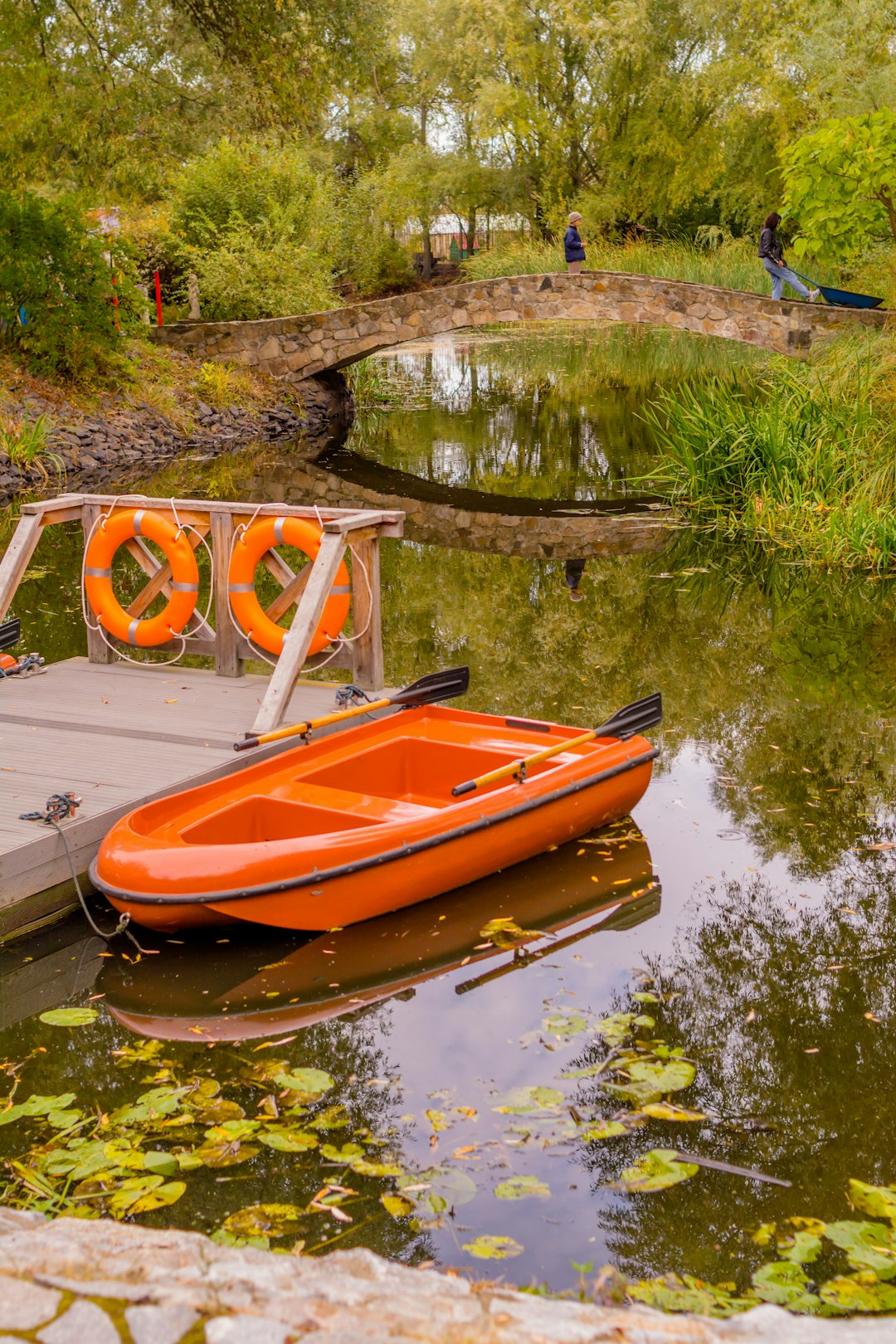 orange boat beside dock