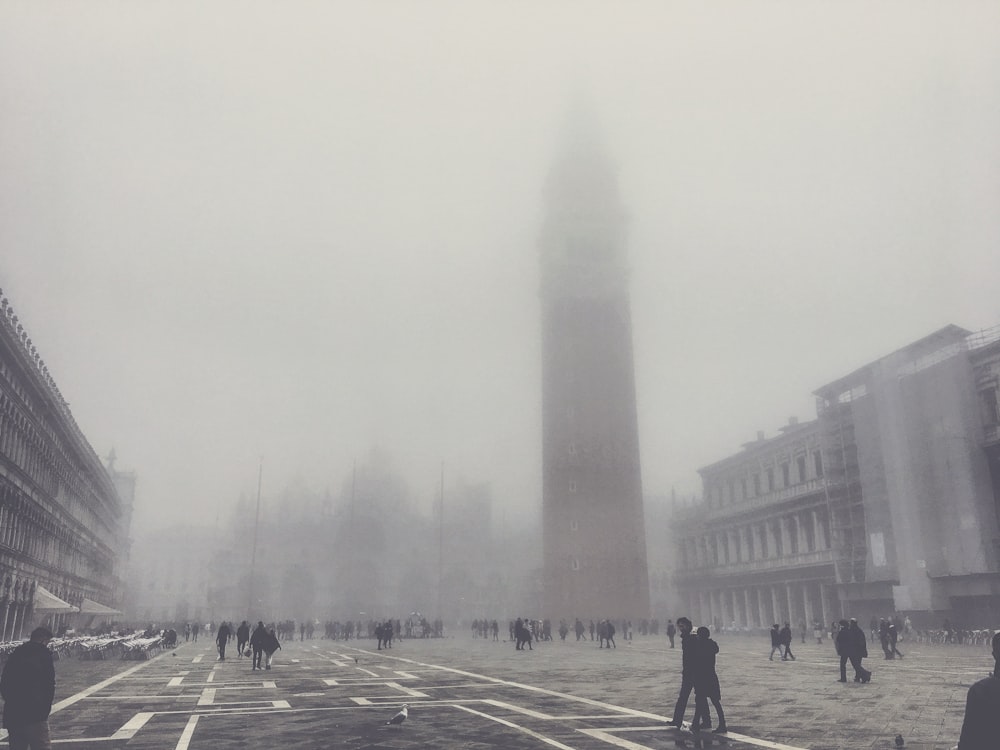 people near gray building during daytime