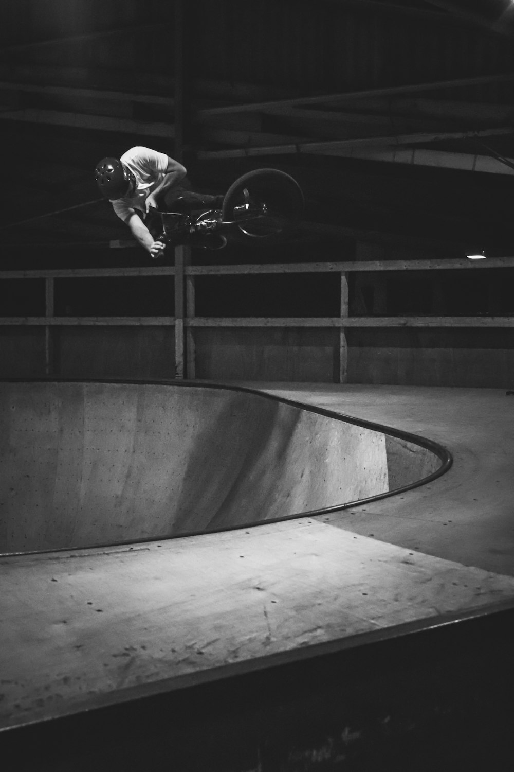 grayscale photo of person riding BMX bike