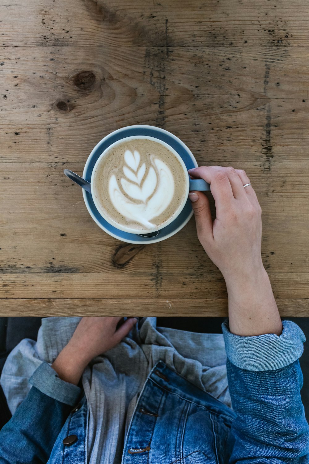 white ceramic mug on brown wooden table