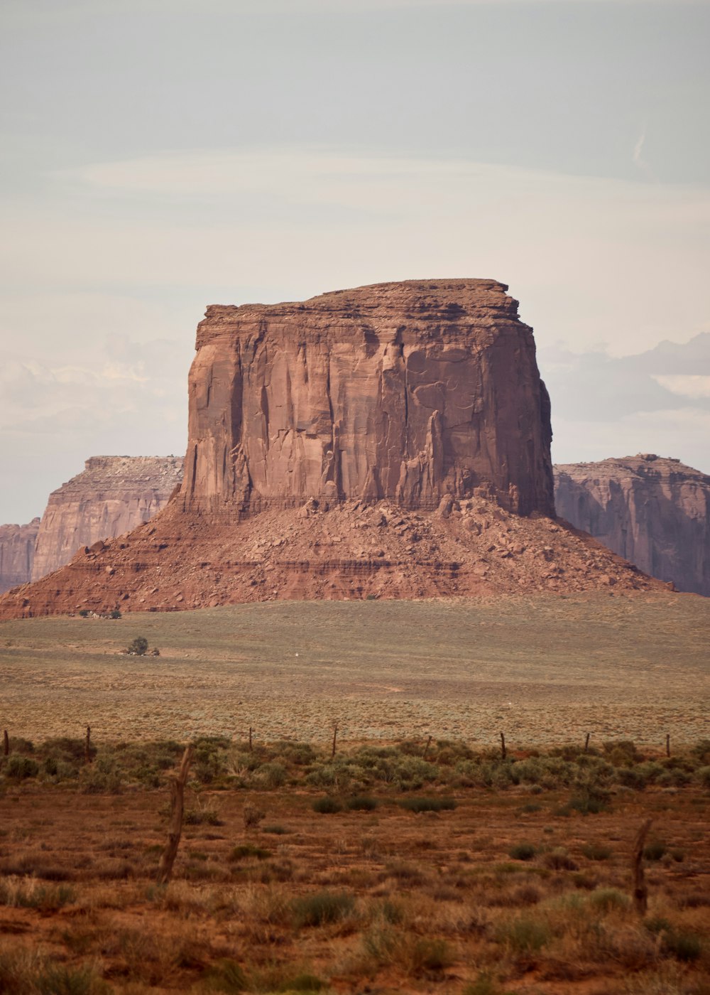 brown rock formation under white clouds