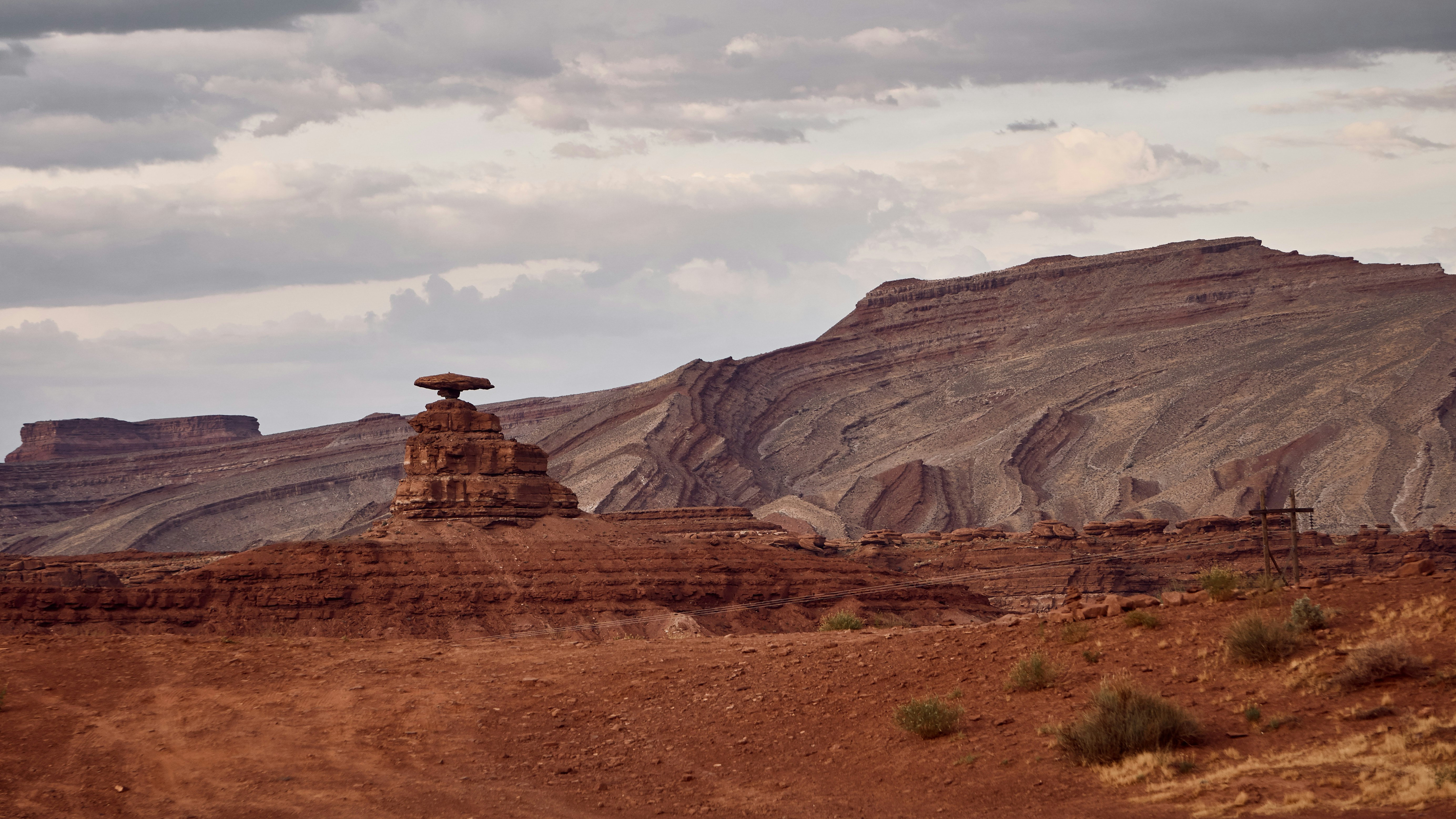 brown rock formations under white clouds