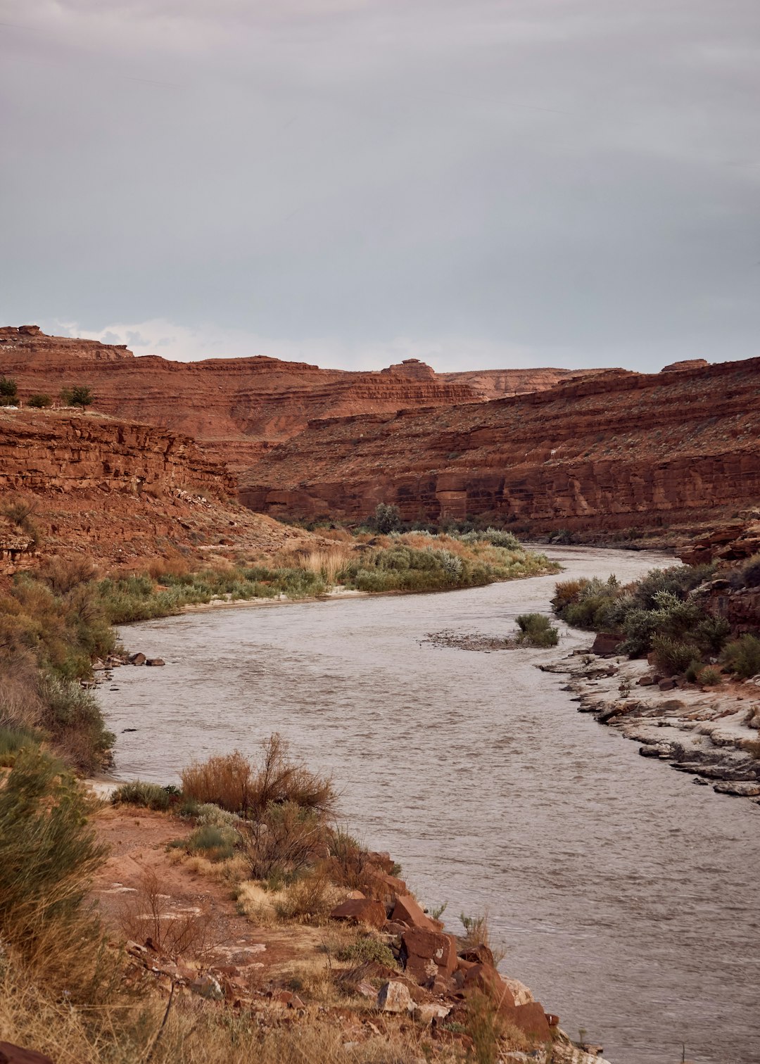 river flows front of rock formation at daytime