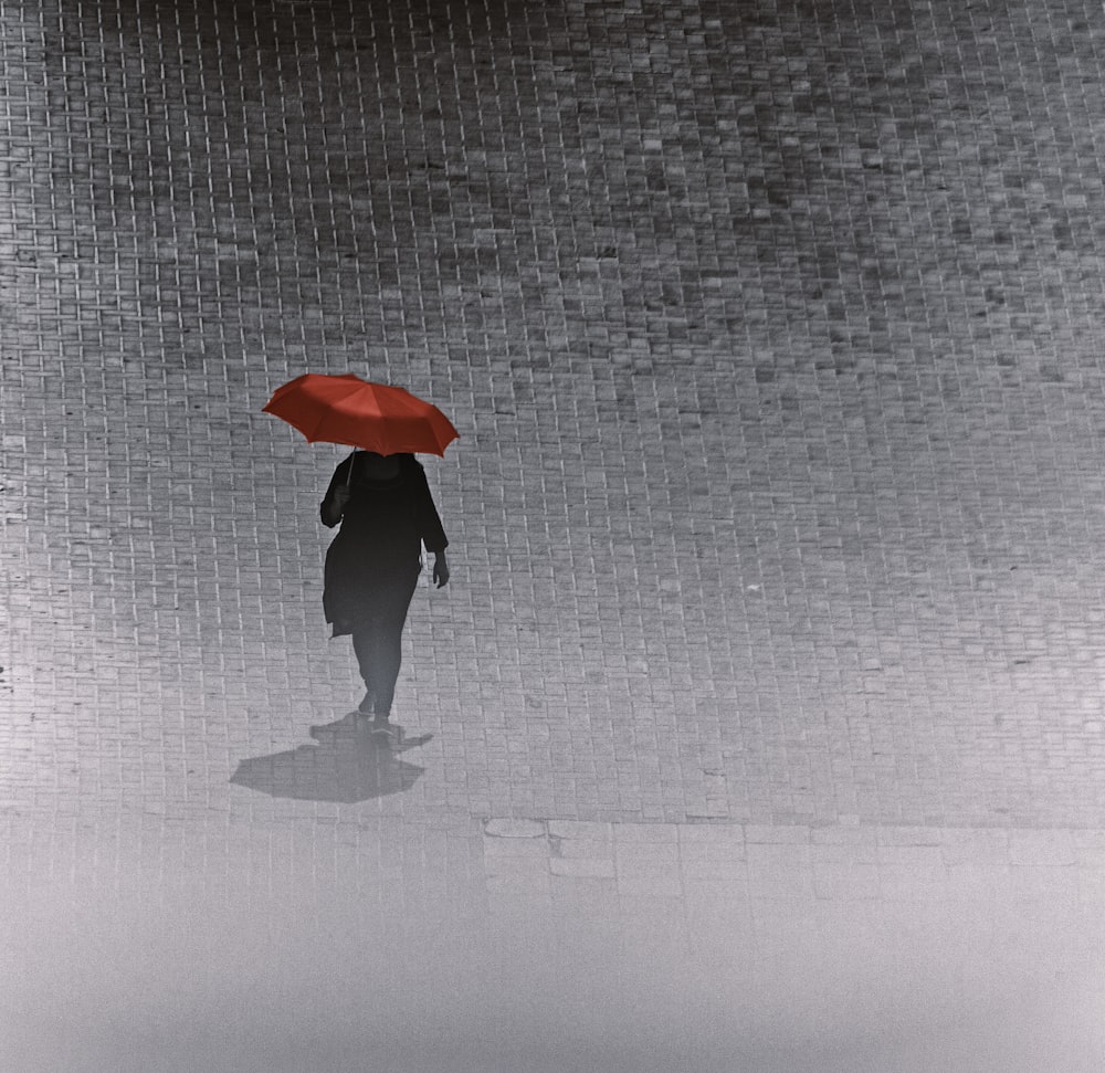 person walking and holding umbrella