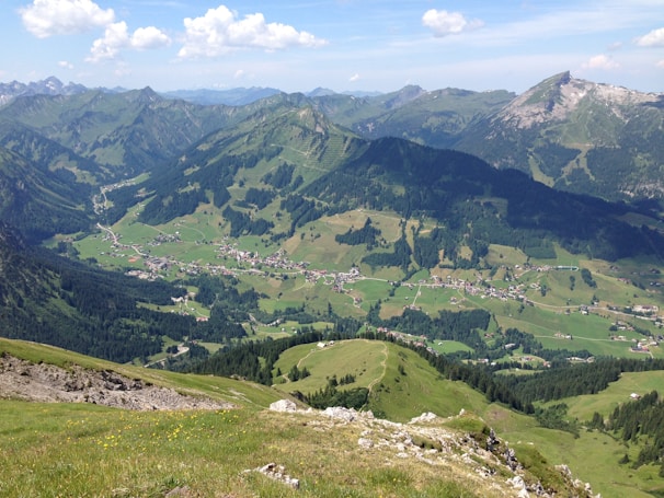 An aerial view of a picturesque valley surrounded by mountains.