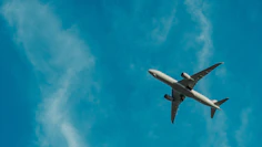 gray airplane flying during daytime