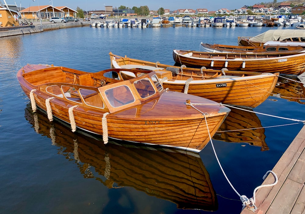 brown boats on body of water