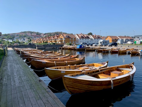 a row of boats sitting on top of a body of water