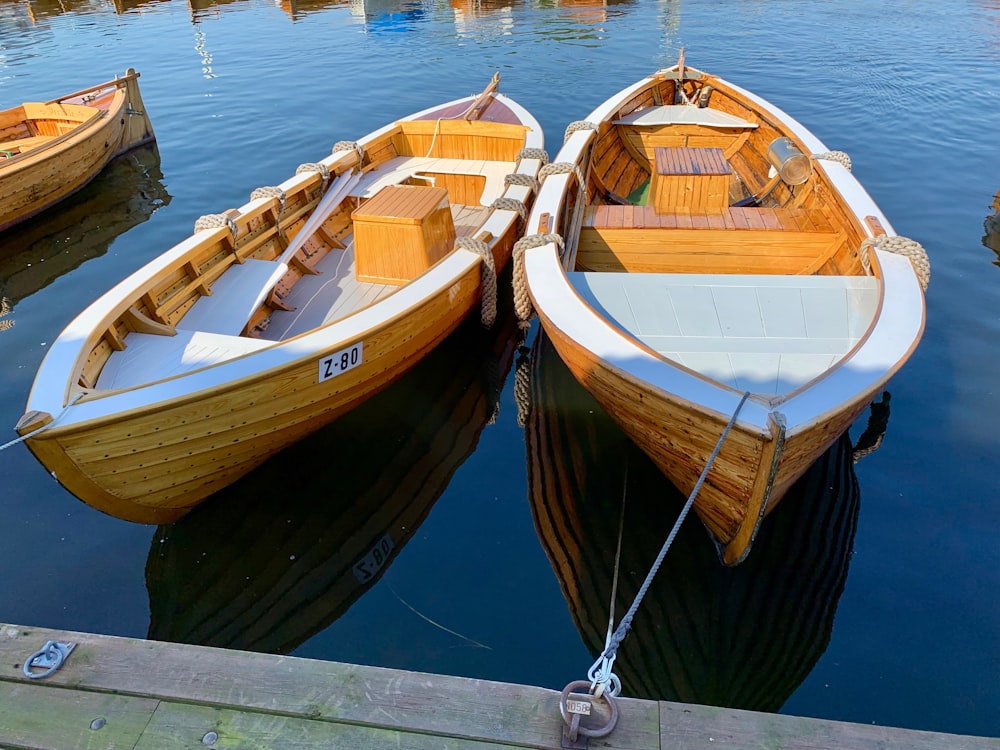 two white and brown boats