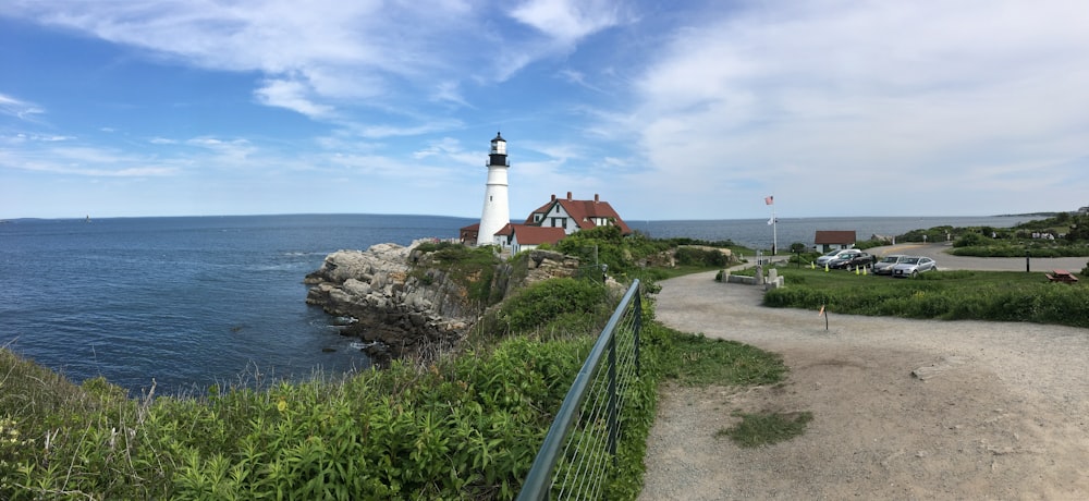 white lighthouse near body of water