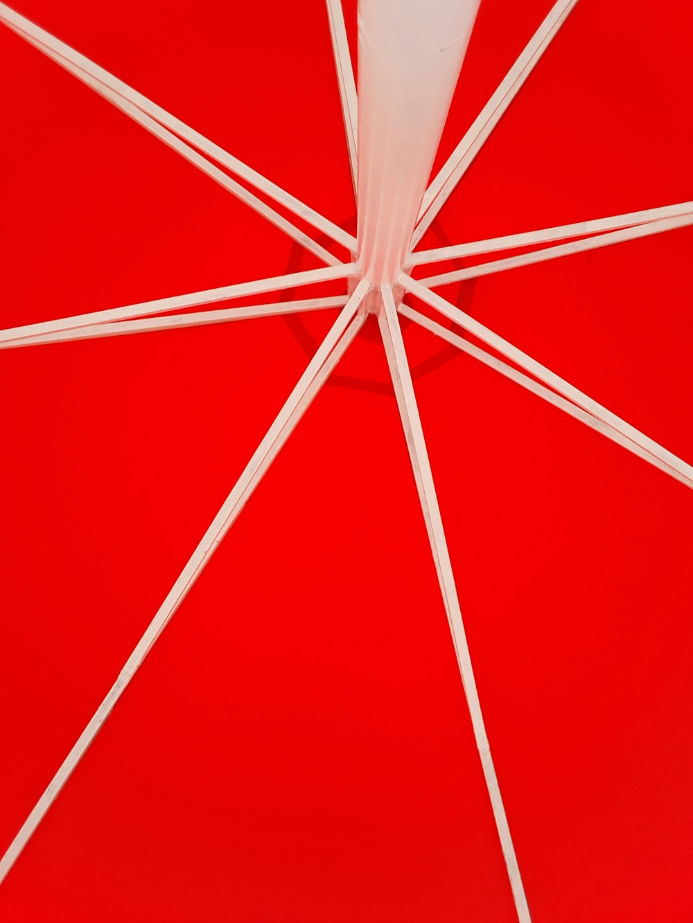 a close up of a red and white umbrella