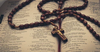 a rosary on top of an open Bible