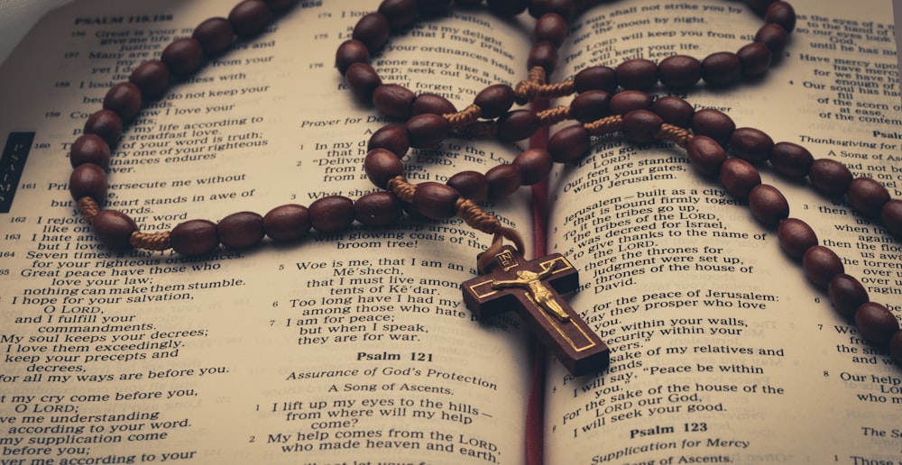 a rosary on top of an open Bible