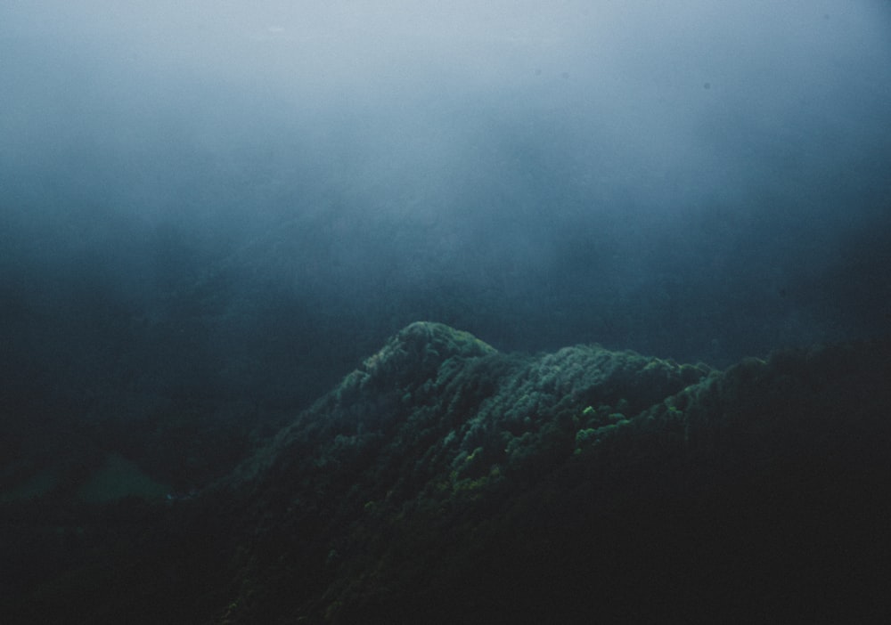 green mountains covered with clouds