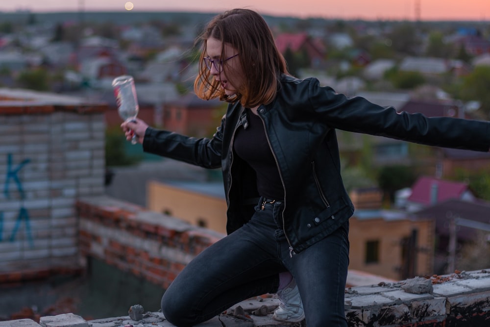 shallow focus photo of woman in black leather jacket