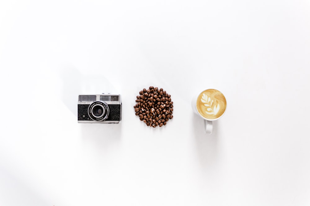 black and gray SLR camera on white surface