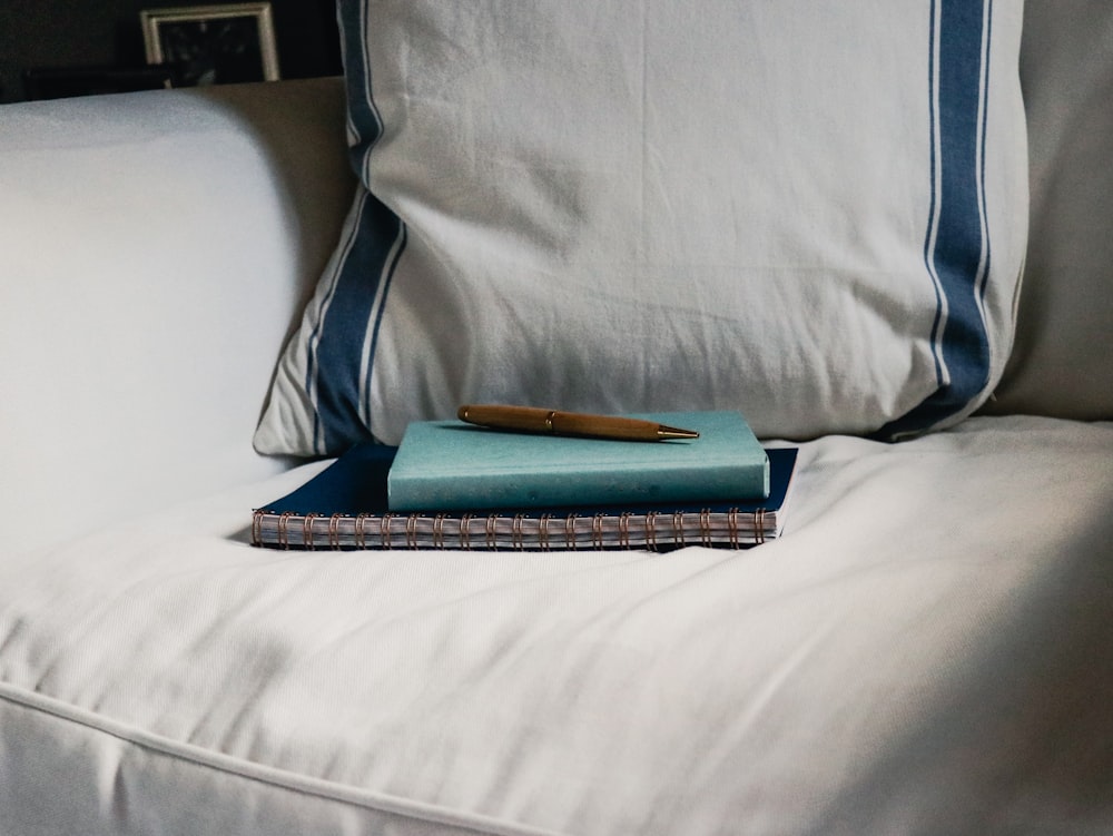 book on top of a notebook in a sofa