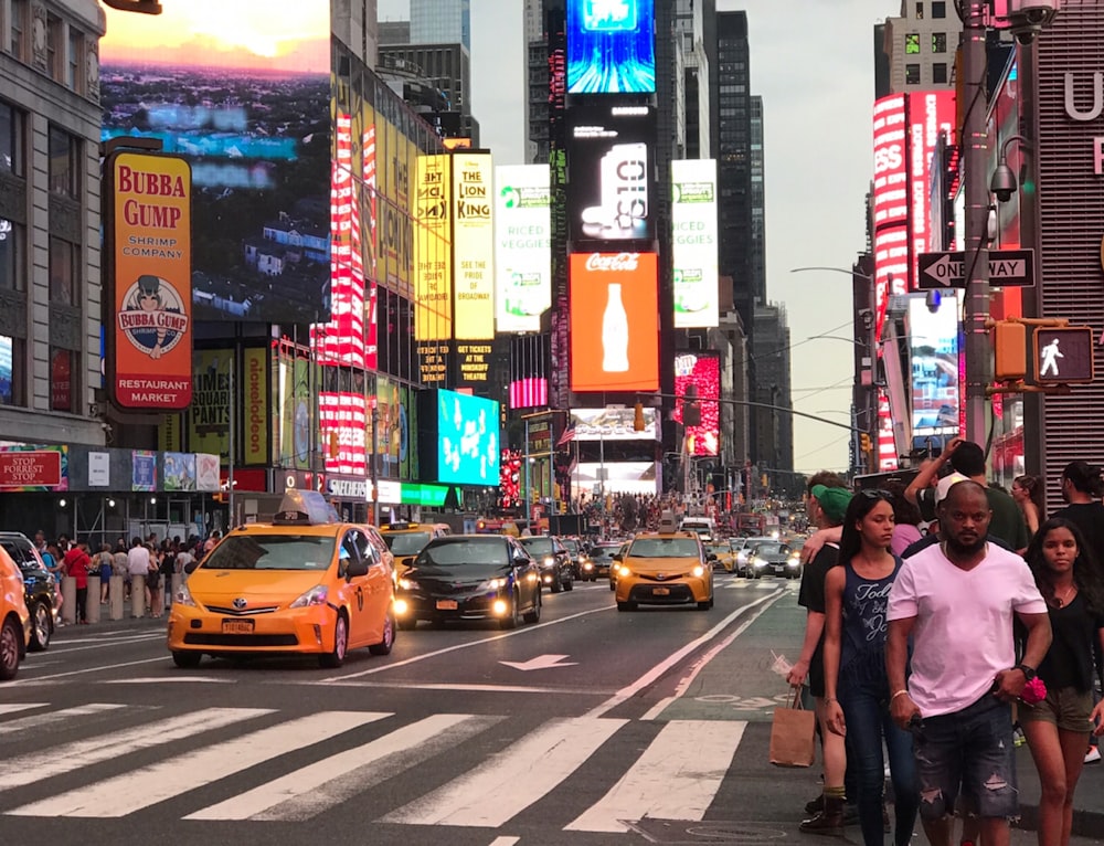 people walking beside road and buildings