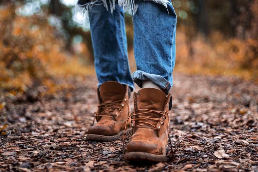 person in brown leather boots