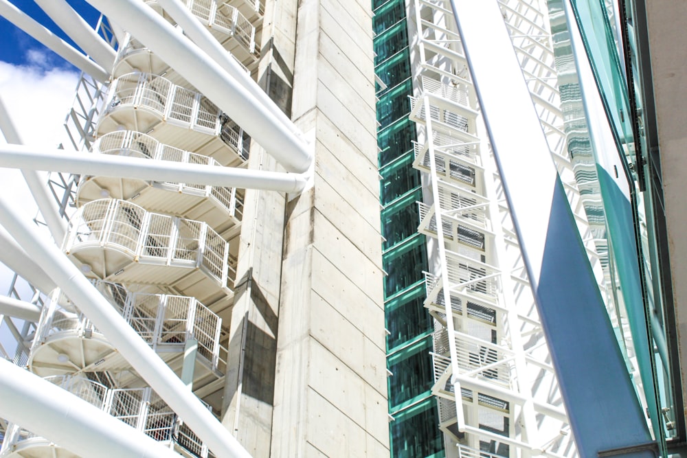 low-angle photography of white and green high-rise building