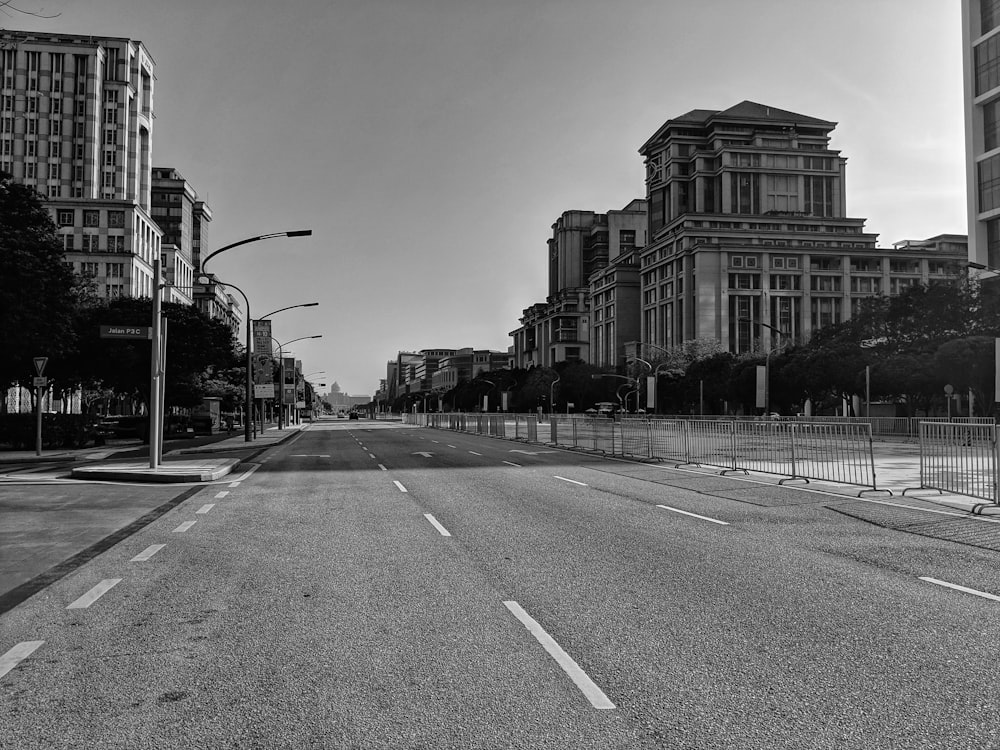 grayscale photography of road and buildings