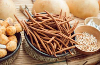 Close-up of a variety of crunchy snacks arranged invitingly on a wooden table.
