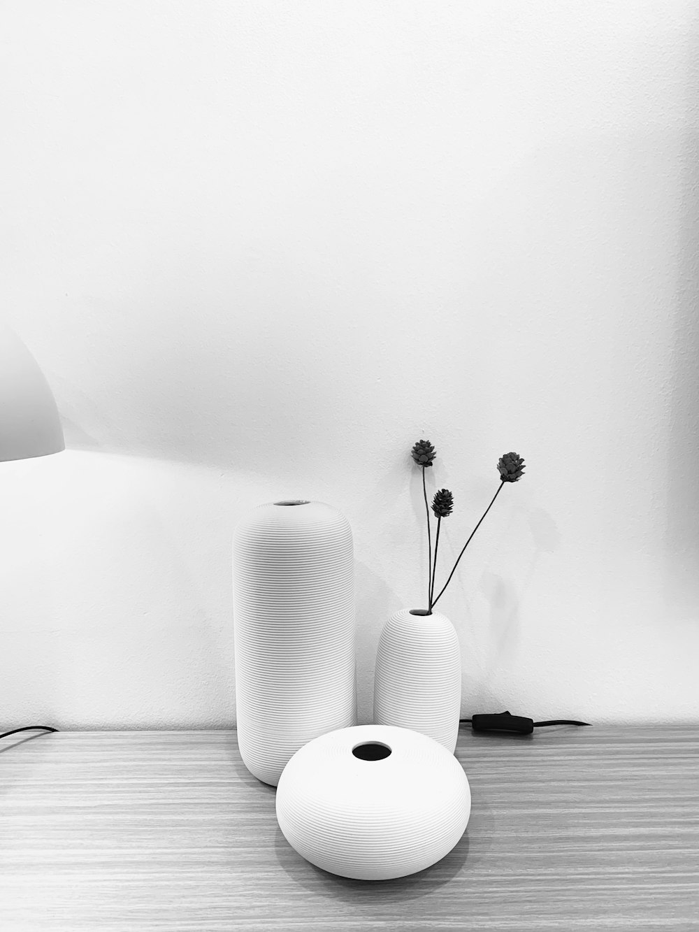 three assorted ceramic vases on table top