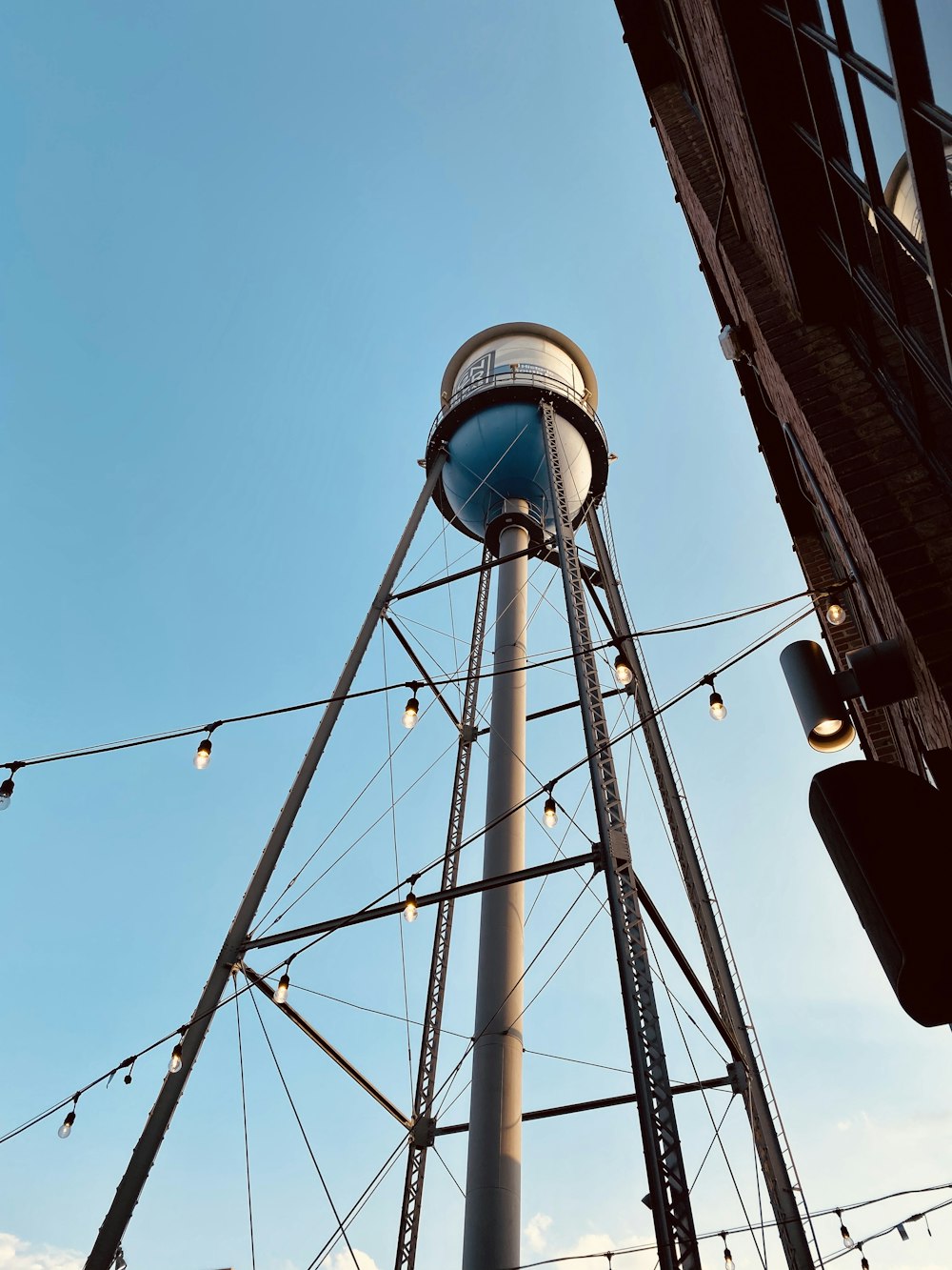 low-angle photography of a blue and white water tank