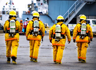four yellow fire fighters