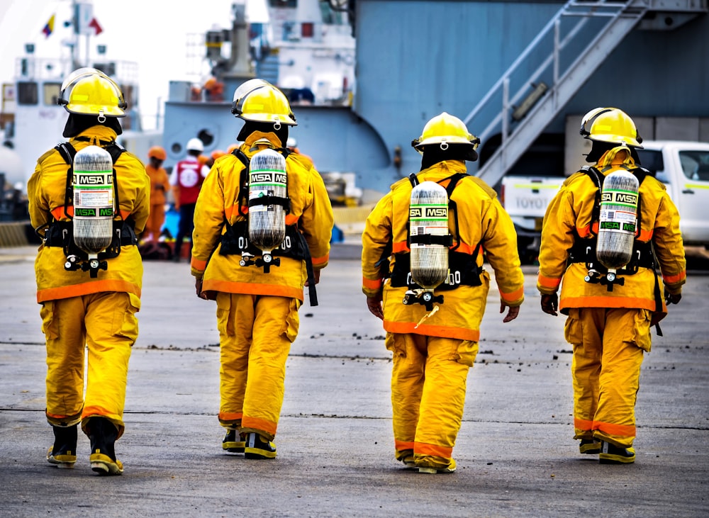four yellow fire fighters