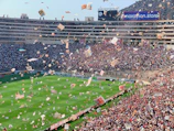 A panoramic view of a local stadium filled with cheering spectators.