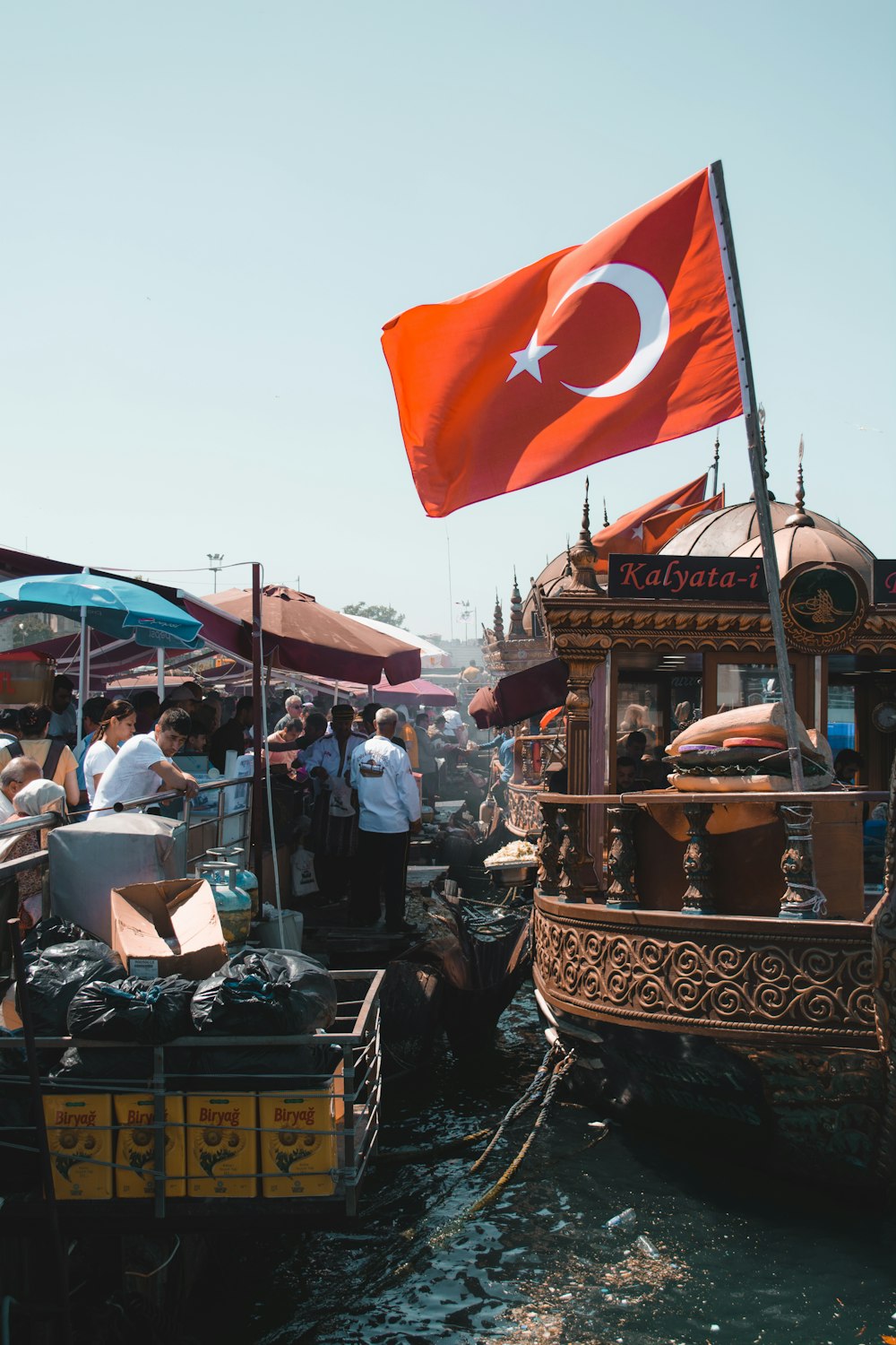 boat with orange and white flag during daytime