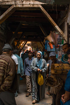 A local tour guide leading a group through a vibrant traditional market in Yogyakarta.